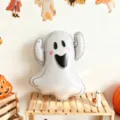 White foil ghost balloon with a cute face, displayed on a wooden shelf in a Halloween party scene - Ghost / 2 Pieces/Pack / White