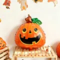 Halloween pumpkin-shaped foil balloon in orange and green, with a cheerful black face - Green Leaf Pumpkin / 2 Pieces/Pack / Orange