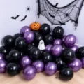 Glossy black and metallic purple Halloween latex balloons displayed with spooky party decorations - Metallic Purple and Matte Black