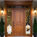 Black-and-gold New Year door hanging with gnomes and printed fireworks, shown on a wooden entrance. - Black Gold Gnome Style (SDL-006)