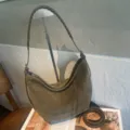 Olive suede-textured bag with braided strap and detachable long strap displayed beside it - 30x6x25.5cm / Green