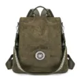 Olive green suede-look convertible backpack with a round metal ornament and patterned webbing strap - Green