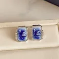 Blue-white floral relief earrings with silver edges, pearl and clear stone accents on a cream case - Square Embossed Style (HE37297) / Blue/Silver