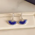 Close-up of blue-and-white glazed fan pendants, pearl-like beads and sparkling silver-toned details - Fan Shape Pearl Style (HE37296) / Blue/Silver