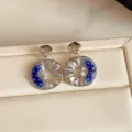 Paired silver-tone earrings with blue floral enamel, openwork spokes and sparkling centers - Hollow Round Style (HE37295) / Blue/Silver
