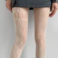 Close-up of cream tights with oval cutouts, diamond mesh and vertical stripe patterns - One Size / Bottoms / White