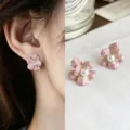 Close-up of pink enamel flower studs with faux pearl centers and gold-tone rims, worn and displayed - Pink Flower Drop Style (6001)