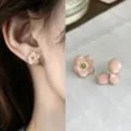 Pink enamel petals with gold-tone edges and yellow centers, shown worn and arranged on fabric - Sakura Pink Style (2265)