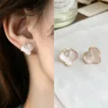 Close-up of pale pink enamel flower studs with gold-tone edges and clear stones, worn and displayed - Gradient Pink Flower Style (4831)