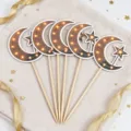 Flat lay of five crescent moon and star cake picks with warm amber lights on wooden sticks - Moon Star (Warm Light Effect)