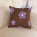 Close-up of purple flowers and white dots on a brown fabric cushion in a cozy living room - 35x35cm / Cushion Cover Only / Brown Floral