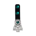 Close-up of green gemstones on black velvet with a silver medallion and dangling bell tassels - Dark Green