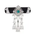Detail of an antique-silver ornament with a green square gem, floral links, beads and bell tassels - Dark Green