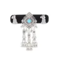 Close-up of a silver-tone ornament with a blue square stone, rhinestones, bells and tassels - Emerald Green