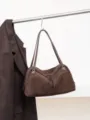 Brown suede-textured bag hanging from a rail, with leather handles, zip closure and silver hardware - 35x12x23cm / Dark Coffee