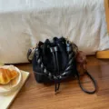 Black suede-look bucket bag with quilted texture, braided handle, drawstring closure and bear charm - With Pendant / Black