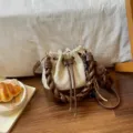 Cream faux-suede bucket bag with brown braided handles, drawstring closure and teddy bear charm - With Pendant / Off White