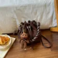 Brown bucket shoulder bag with drawstring closure, braided handle, metal hardware and bear charm - With Pendant / Coffee