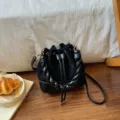 Black suede-look bucket bag with diamond quilting, braided handle, gold hardware and drawstring - No Pendant / Black