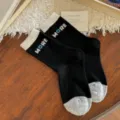 Black women's crew socks with cream ribbed cuffs, gray toes and blue-white MORE lettering - One Size / Black