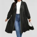Full-length view of a model in a black hooded coat, cinched waist, zip front, and blue jeans - 0XL / Tops / Black