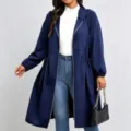 Model wearing a navy hooded long coat with a cinched drawstring waist and elastic cuffs - 0XL / Tops / Navy Blue