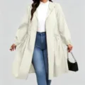 Full-length view of a model wearing a light cream hooded coat with a drawstring waist and flared hem - 0XL / Tops / Off White