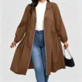 Model wearing a brown hooded coat with drawstring waist, zip front and flared hem over jeans - Coffee