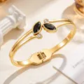 Gold-tone stainless steel cuff bracelet with black marquise stones, clear accents and spring clasp - Black (SZ6143)