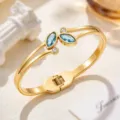 Gold-tone stainless steel cuff bracelet with blue marquise-cut stones and clear round accents - Light Blue (SZ6143)