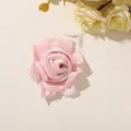Top-down view of a soft pink fabric rose with layered, slightly frayed petals on a pale surface - Style 3(A35-6–6-10) / 1 Piece/Pack