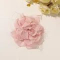 Overhead view of a pink layered mesh flower with shimmering fibers on a light beige background - Style 21(A38-2-1-3) / 1 Piece Pack