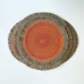 Round braided table mat with a vivid red-orange-yellow spiral center and natural beige fringe - Orange Red (Jute Tassel)