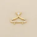 Close-up of a gold-tone hanger-shaped jewelry connector with white zircon stones and two loops - Gold