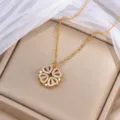 Goldfarbene Kleeblattkette mit weißen Zirkonsteinen, auf einer beigen Schmuckbox präsentiert - Gold Kleeblatt (X0005) / Gold