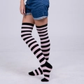 Close-up of pink and black striped over-the-knee socks paired with denim shorts - Light Pink Black Wide Striped