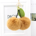 Detail of plush cherry keychain with light brown faux fur balls and green leather leaf - Coffee