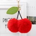 Detail of fluffy red cherry pompom keychain with green leaves and golden metal clasp - Red