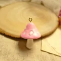 Close-up of pink resin mushroom pendant with white dots for DIY jewelry making - Pink