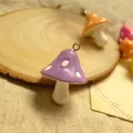 Macro shot of purple resin mushroom charm with white dots and metal ring hook - Purple