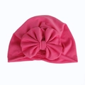 Dettaglio del turbante per neonati in cotone fucsia con un grande fiocco morbido - Rosa Rossa