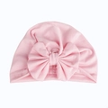 Detailed view of pink cotton baby turban hat with a large bow on white background - Pink
