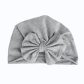 Detail of soft heather grey knit baby turban hat featuring a large matching fabric bow - Gray