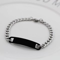 Silver Cuban link bracelet with a sleek black metal ID plate on a ceramic plate - Black Bar (Silver Chain)