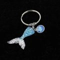 Exquisite mermaid tail keychain with gradient scales and silver alloy clasp on black velvet - Blue & Silver