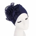 Detail of elegant navy blue turban featuring a large side-layered floral decoration - Navy Blue