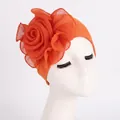 Detail of elegant orange turban hat featuring a large 3D chiffon rose on high-elastic fabric - Orange