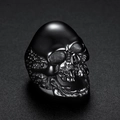 Detailed close-up of a vintage skull ring in gun black finish with gothic punk metal texture - US 7 / Black (05406)