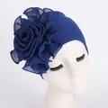 Detail of dark blue turban hat featuring large layered chiffon flower on stretch fabric - Sapphire Blue