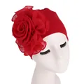 Detail of elegant red turban hat featuring a large layered chiffon side flower decoration - Red